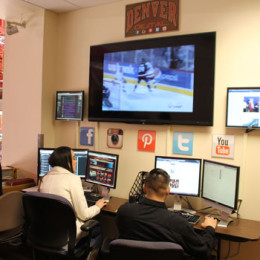 Students man the social-media hub during a recent hockey game. Photo: DU Athletics